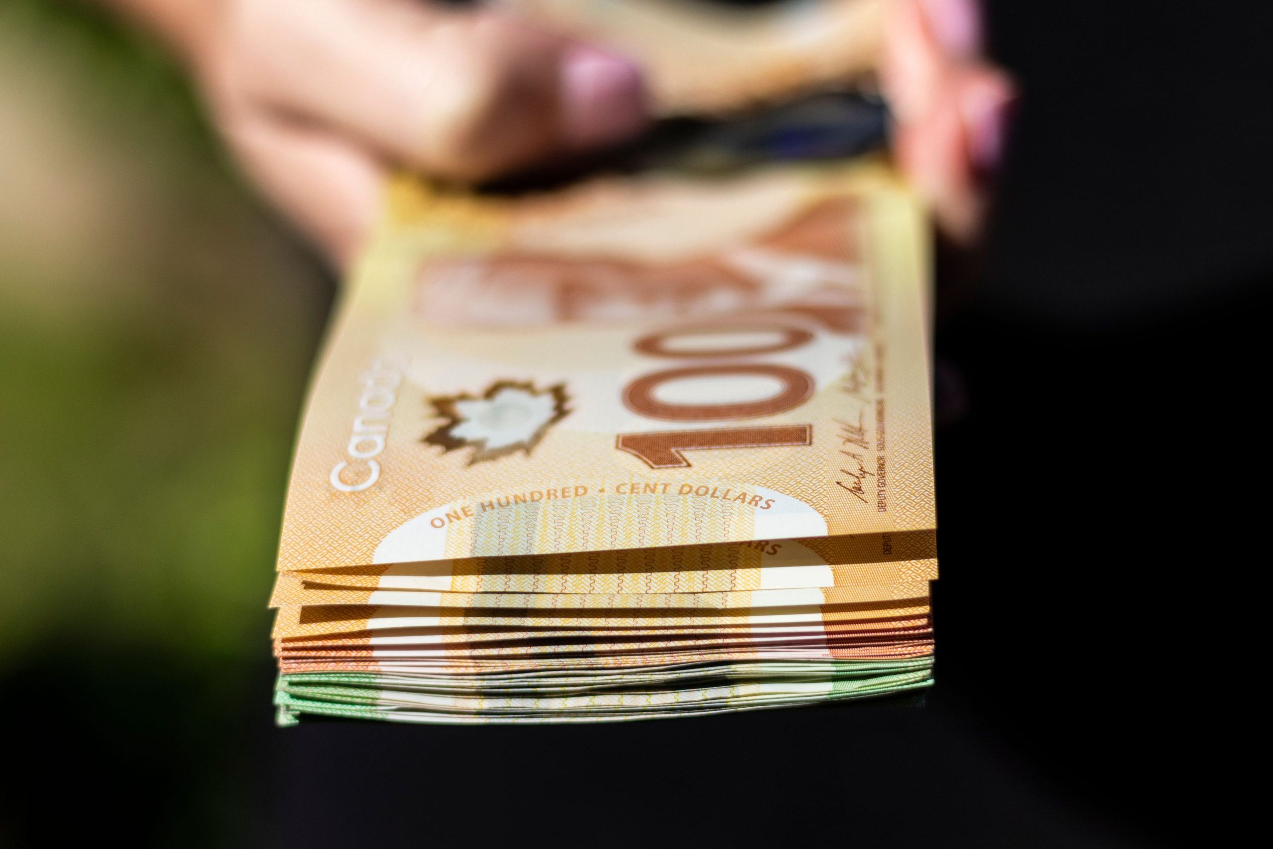 Closeup of Canadian cash in the hands The closeup of Canadian cash in the hands